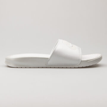 VIENNA, AUSTRIA - FEBRUARY 19, 2018: Nike Benassi JDI Metallic white sandal on white background.