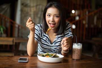 Young Asia woman eating spaghetti at restaurant
