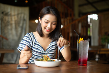 Young Asia woman eating spaghetti at restaurant