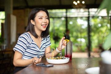 Young Asia woman eating spaghetti at restaurant
