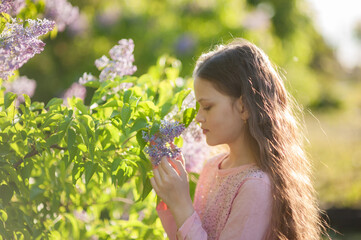 Outdoor close up portrait of young beautiful happy smiling girl, long curly hair, no makeup. Summer sunny day. Female natural beauty, happiness concept