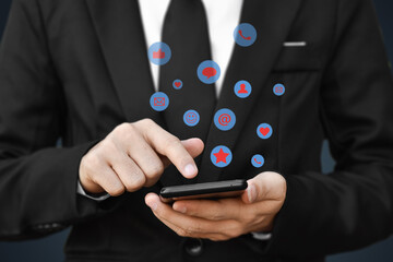 Close-up of businessman hands using mobile smartphone with social media icon. Idea for business, online marketing and technology.