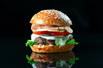 Juicy beef Burger on a black background.