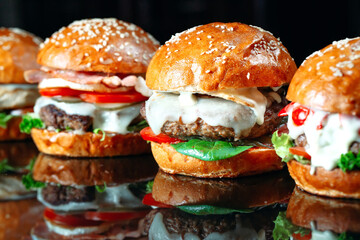 Juicy beef Burgers on a black background.