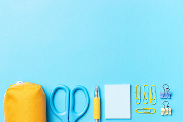 Stationery on a blue background with a copy of space, concept of returning to school