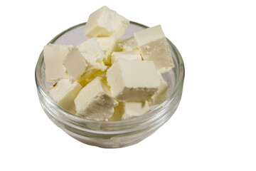 Feta cheese cubes in glass bowl isolated on white background