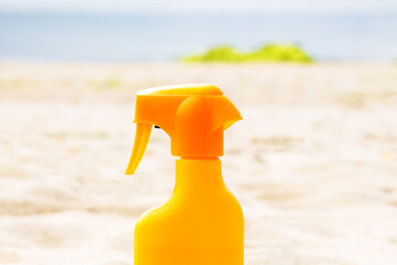 suntan lotion on the beach sand, summer vacation concept