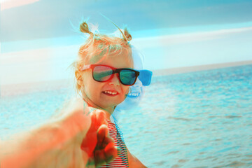a child pulls father to swim in the sea. Double Exposure
