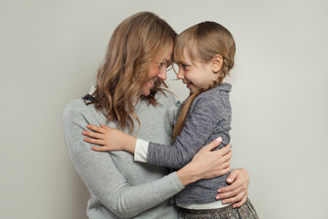 Happy mother and little daughter hugging. Happy family.