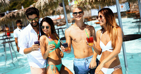 Group of happy friends having fun on tropical beach, summer holiday party