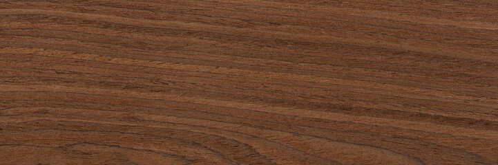 Perfect nut veneer background in brown tone. Natural wood texture, pattern of a long veneer sheet, plank.