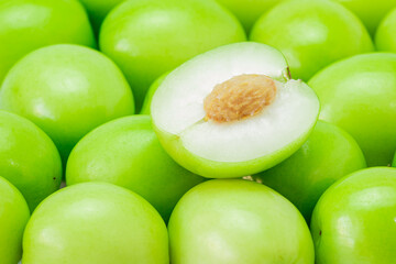 Half of a jujube green fruit, on pile isolated on white background. The file includes a clipping path easy to use. Close-up.
