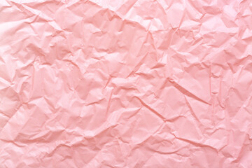 Crumpled paper texture. Pastel pink trendy abstract background.