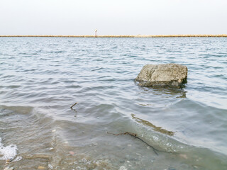 beautiful view of rock inside seawater at a beach  
