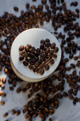 cosmetic jar with coffee beans on background