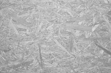 OSB for construction work. Oriented particle board. Wood background. Background from shavings. Wooden texture.