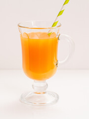 Glass of fresh orange juice on a white background.