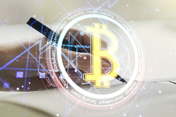 Creative Bitcoin concept with man hand writing in notebook on background. Multiexposure