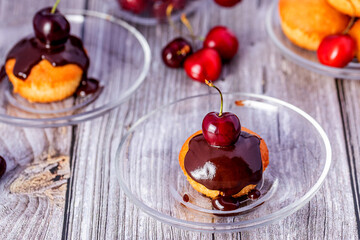 Homemade cupcakes with cherries and chocolate. Classic dessert.