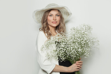 Cheerful blonde woman model with flowers