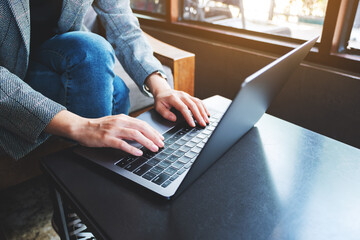 Closeup image of a businesswoman working and typing on laptop computer