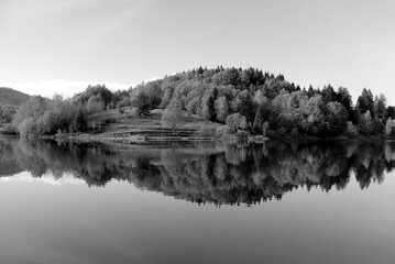 B&W of hill and woods reflection in the lake water