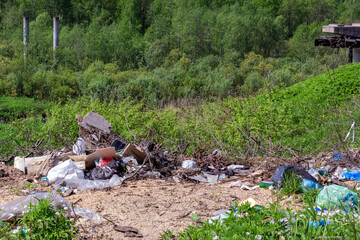 Garbage dump on a green meadow. Nature pollution.