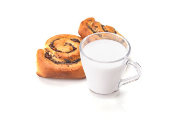 Homemade cream roll with strawberry jam and cup of milk. Isolated on white background.