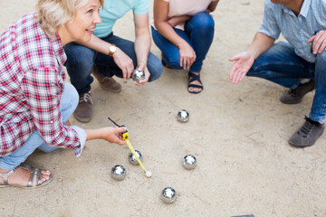 Smiling mature people playing petanque