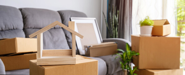 Stack of cardboard boxes in living room at new house on moving day