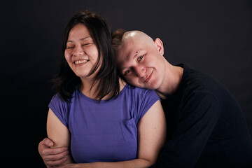 Portrait of mixed race couple in the studio. Two people together hug.