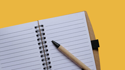 Spiral book on yellow background. Paper notebook