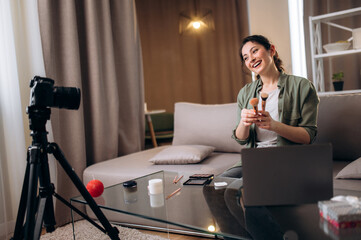 Recording a new vlog for channel. Caucasian beautiful girl blogger tells her subscribers about her...
