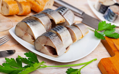 Closeup slices of slightly salted herring with parsley