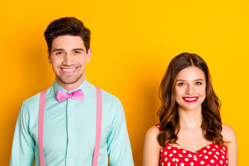 Photo two amazing beautiful people lady handsome guy toothy smiling prom couple wear red dotted dress shirt bowtie elegant retro clothes isolated yellow bright color background