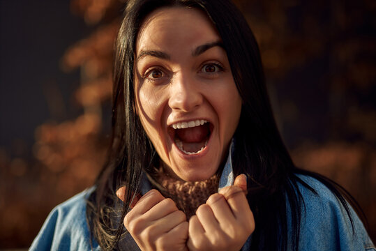 Face of an emotional nice-looking female screaming with delight outdoors