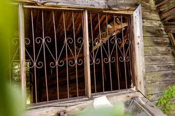 old wooden houses window with bars