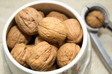 Walnuts in a white ceramic jar. Nuts are the basis of a healthy diet.