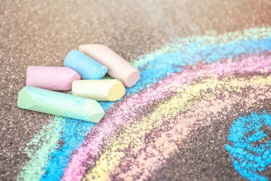 Sidewalk chalks close-up. rainbow chalk painting. Summer outdoor activity for children idea.