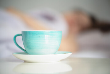 Woman is drinking a morning coffee from a cup close up.
