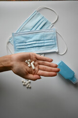 Hand holding pills against viruses and diseases,
bacteria and coronavirus