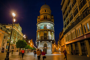Fototapeta premium Night view of an illuminated street in the center of Seville, Spain.
