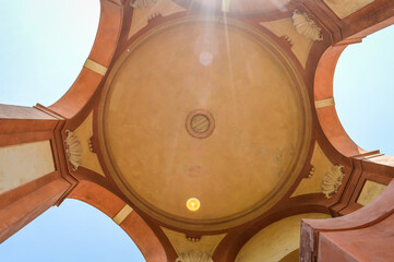 Bottom view of arcades of Sanctuary of Madonna di San Luca on blue sky. Architectural details of ancient historical church. Bologna, Italy © sebastianosecondi