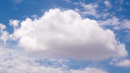 Big single nature white cumulus cloud on clear blue sky background