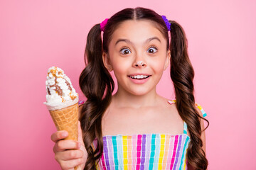 Closeup photo of beautiful funny little lady two long tails hold big cone gelato cream spot on nose carefree good mood girlish wear summer dress isolated pastel pink color background