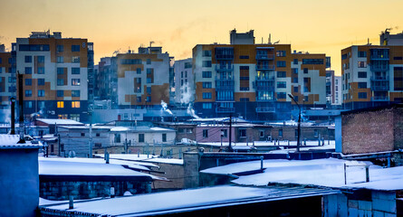 evening under winter city with many multi storey houses