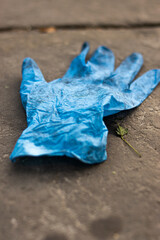 Photo of a close up plastic glove thrown away in the streets of London