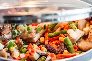 Assorted different vegetables in a pan in sunflower oil