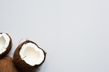 top view of fresh tasty whole coconut and halves on white background