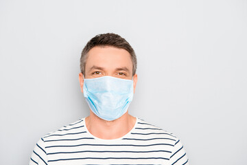 Happy handsome mature man with medical mask wear on face isolated on gray background, stop pandemic of corona virus concept